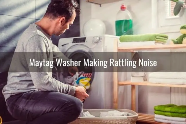A guy pulling clothes out of washing machine