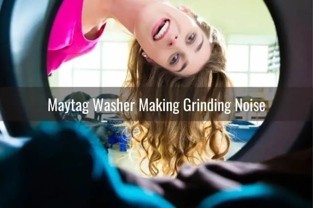 Woman looking into glass door of washing machine