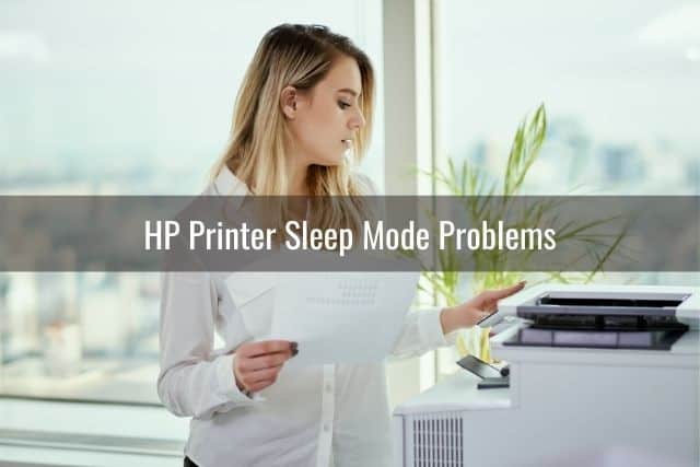 Woman in an office about to press print button on a printer