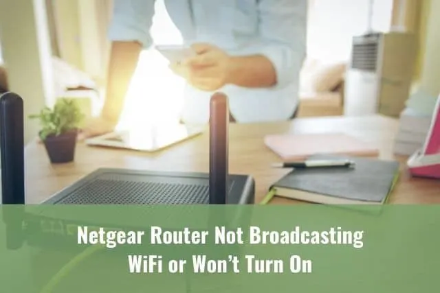 Man with a smartphone and router trying to connect to the Internet