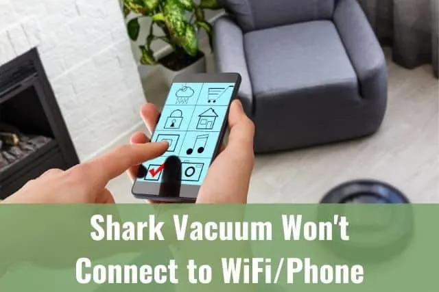 A person using a smartphone app to control robotic vacuum