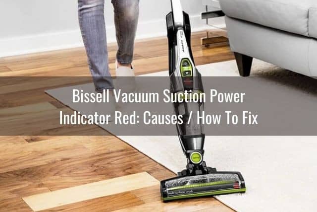 Upright vacuum cleaner on white rug