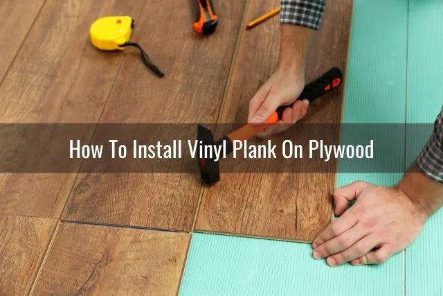 Installation of vinyl floor planks with hammer and measuring tape