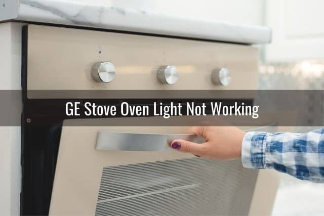 Hand opening up stove oven door