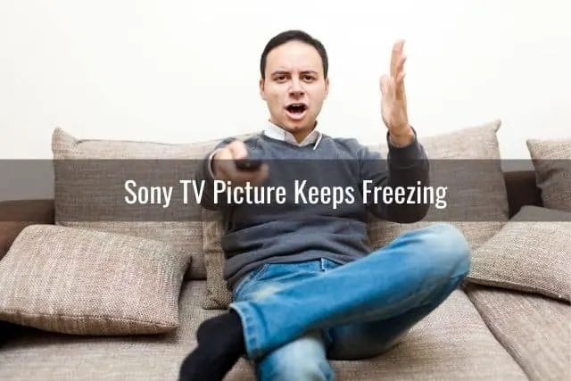 Angry man changing TV channels with remote