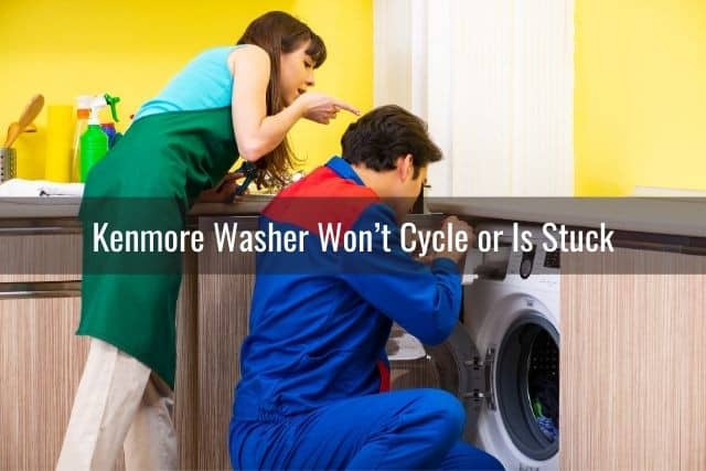 Handyman repairing washing machine