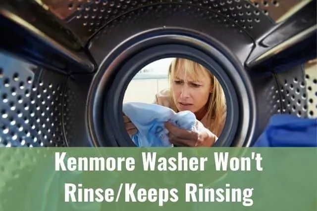 Woman looking at laundry pulled from washing machine