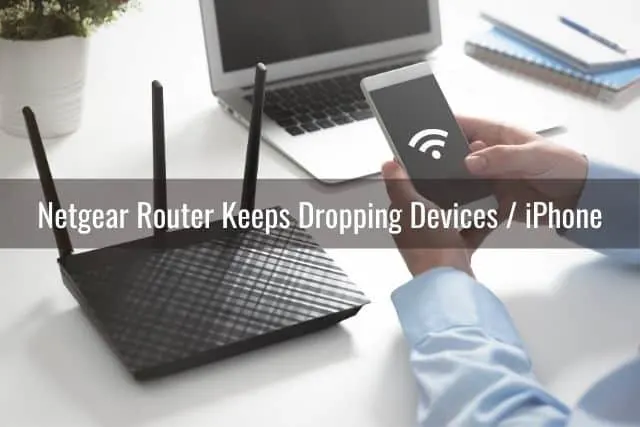 An iPhone searching for a WiFi signal with a black router in the background