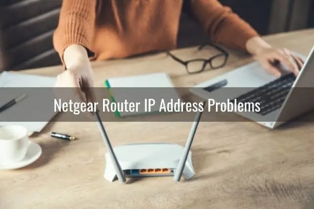 White wireless router with a person adjusting antenna