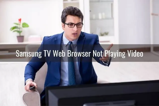 Annoyed businessman watching TV