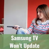 Girl sitting on sofa holding TV remote