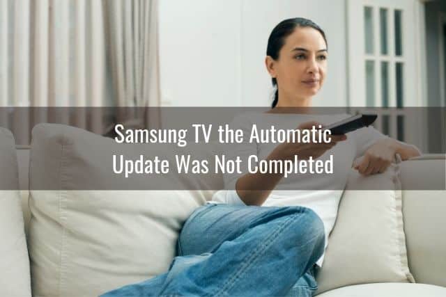 Woman sitting on white sofa with TV remote