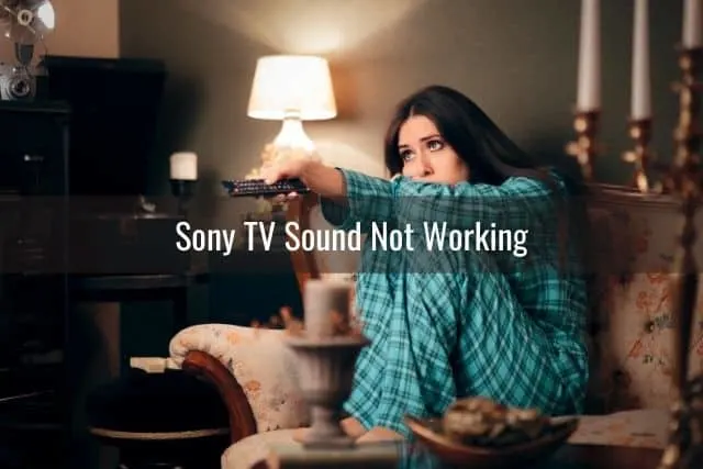 Woman in pajamas holding remote and changing TV channels