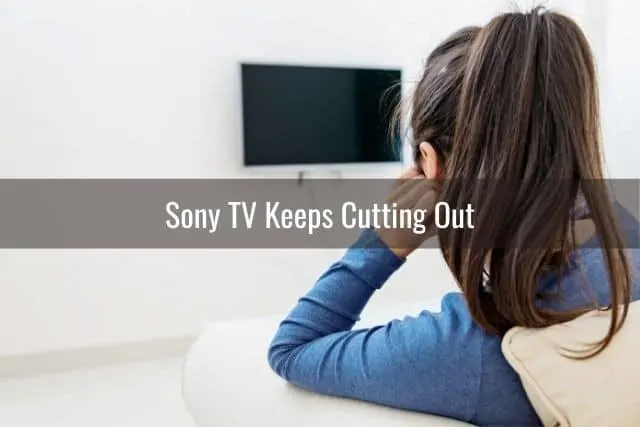 Female sitting in front of TV that's turned off