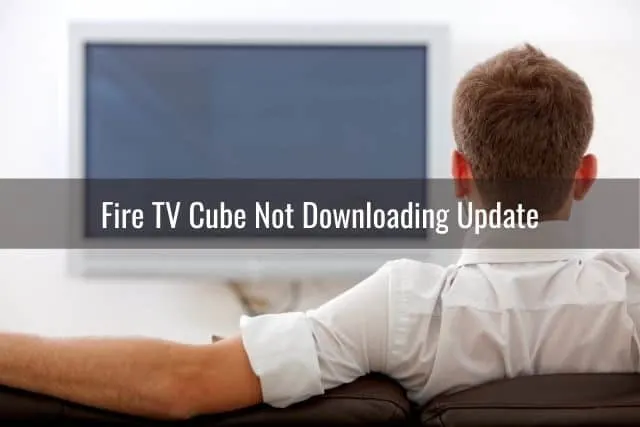 Guy sitting on sofa watching TV