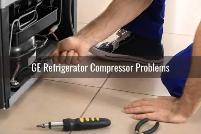 Guy fixing bottom of fridge