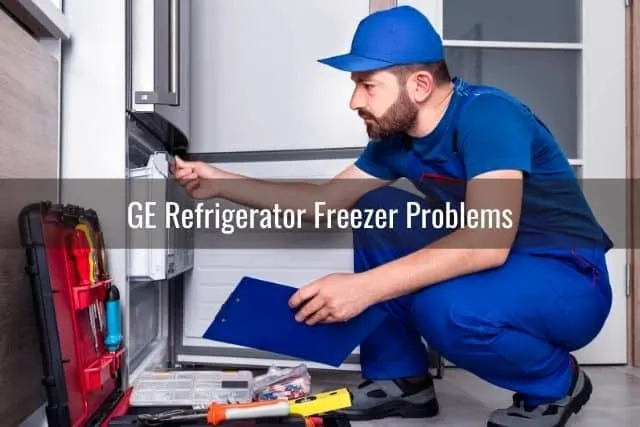 Repairman fixing refrigerator freezer