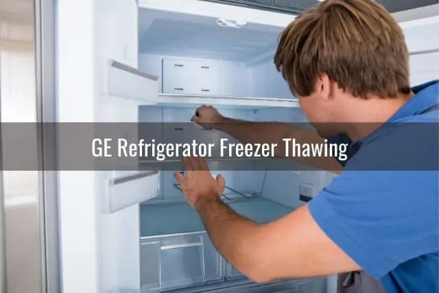 Repairman fixing refrigerator freezer