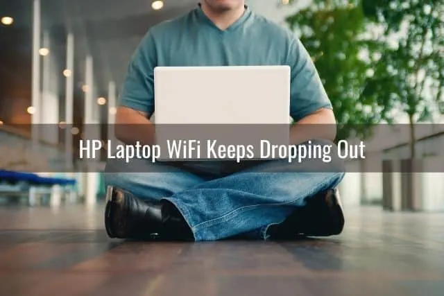Male sitting on the floor with a laptop