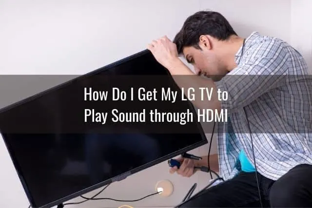 Male setting up cables on TV