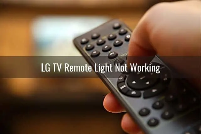 Hand using TV remote