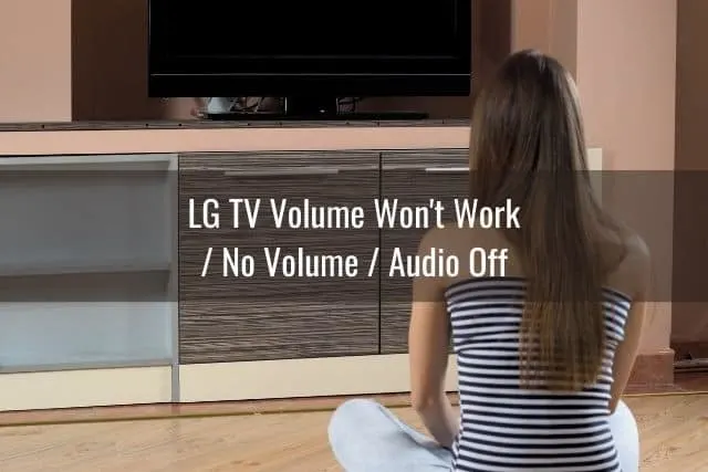 Female sitting on floor staring at blank TV screen