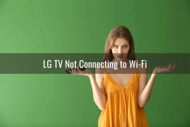 Annoyed female holding TV remote with green background