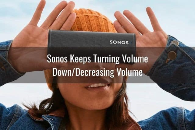Female holding up portable speaker