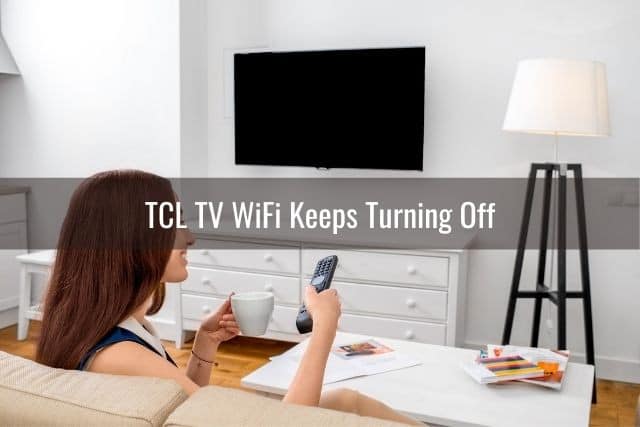 Woman using remote to turn TV on
