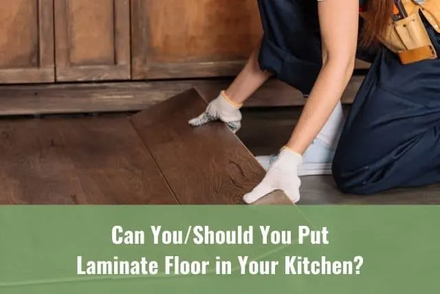 Worker laying down laminate floor planks