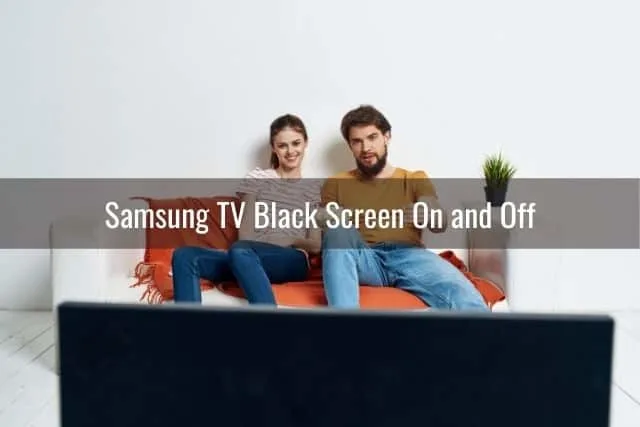 Couple sitting on sofa watching TV