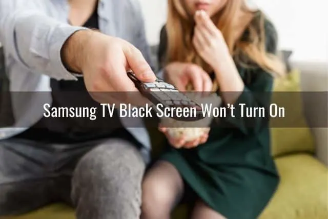 Couple watching TV with male using remote to change channels