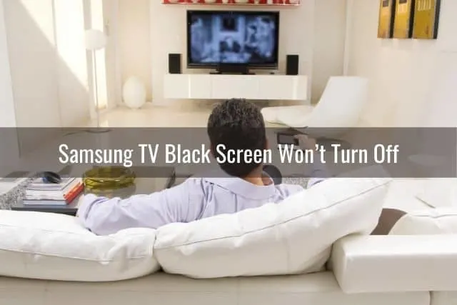 Male sitting on sofa watching TV