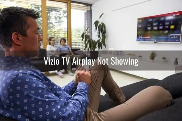 Male using phone while watching TV