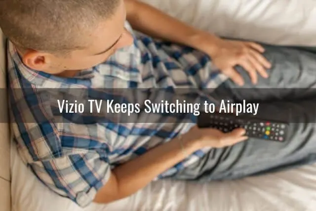Man holding TV remote
