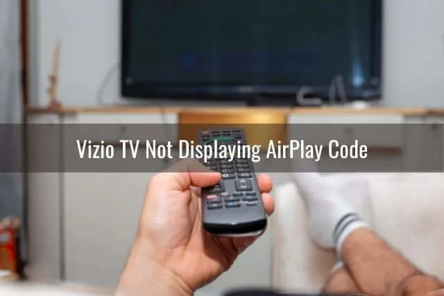 TV remote pointed at screen to turn on