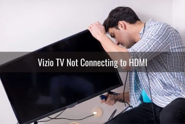 Male plugging cables into the back of TV