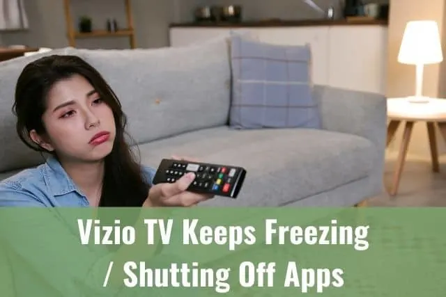 Bored female sitting on living room ground channel surfing on TV