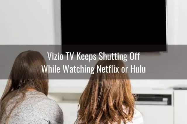 Two young girls watching TV