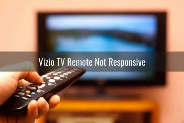 Hand holding TV remote changing channel programming