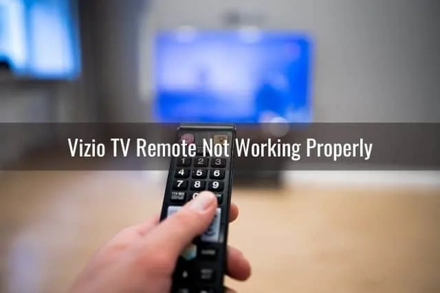 Hand holding TV remote controlling TV screen