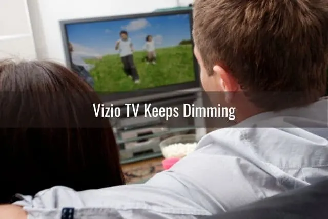 Couple watching TV together on sofa