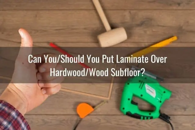 Hand giving thumbs up to laminate flooring installation