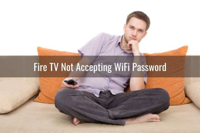 Pensive male sitting on floor with TV remote in hand