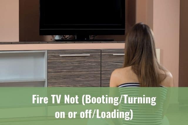 Female sitting on the ground looking at a blank TV screen