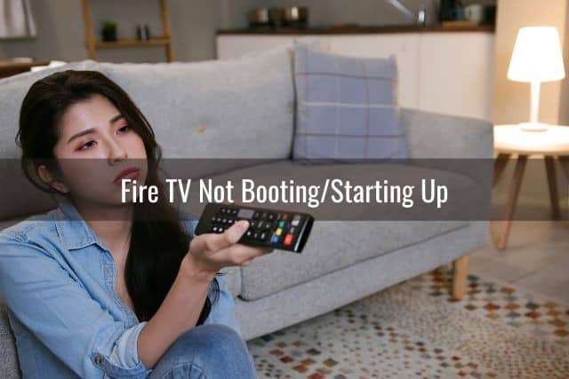 Bored looking female sitting on living room floor watching TV