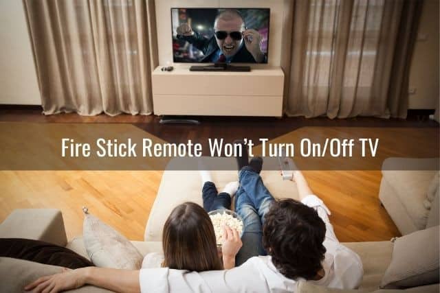 Top view of couple sitting on sofa watching movie on TV