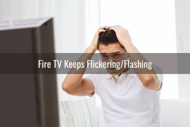 Frustrated male with hands on head while watching TV