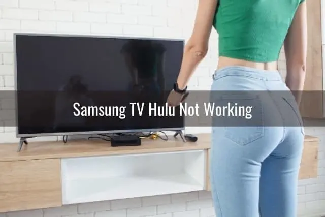 Female using remote to turn TV on