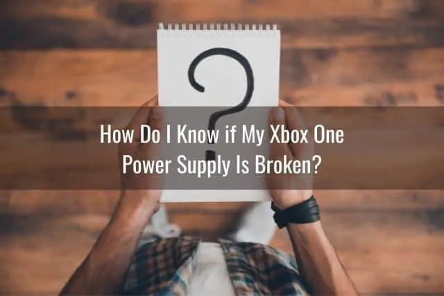 Male holding a notepad with a question mark 